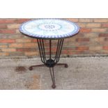 Decorative garden table with mosaiced marble top.