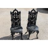 Pair of decorative cast iron garden chairs.