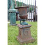 Cast iron urn on plinth.