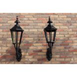 Pair of black cast iron wall lights.