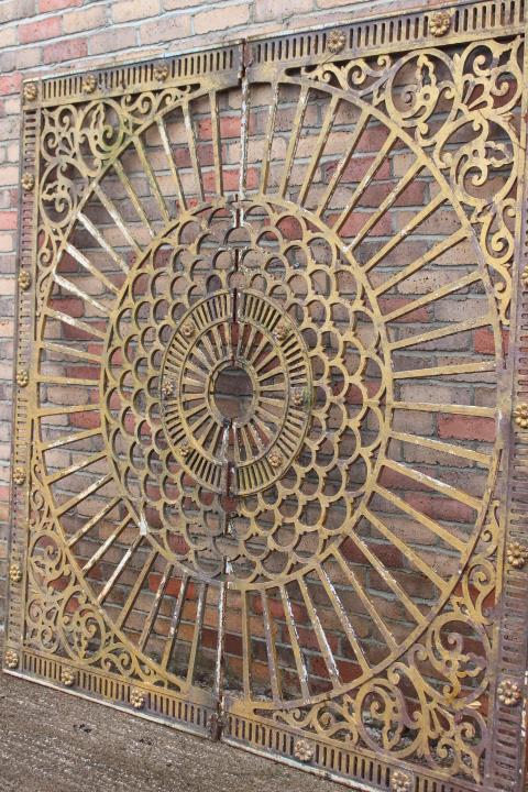 Decorative cast iron sun burst wall feature.