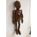 Carved wooden model of Pinocchio puppet .