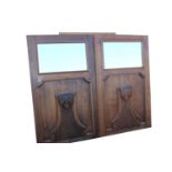 Pair of mirrored carved oak panels.