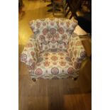 Deep buttoned back floral tub chair.