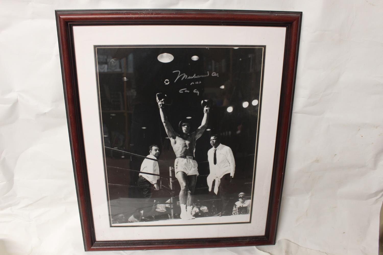 Framed Muhammad Ali signed photo.