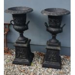 Pair of cast iron urns.