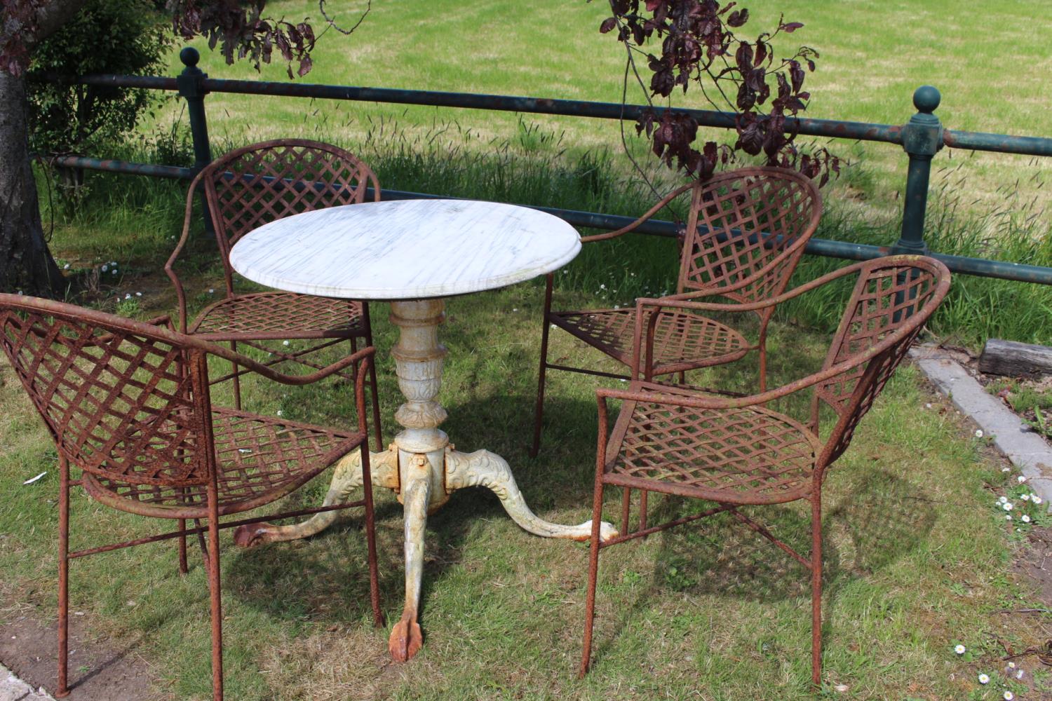 Cast iron garden table and four chairs.