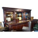 Exceptional quality carved mahogany mirrored bar back and counter.
