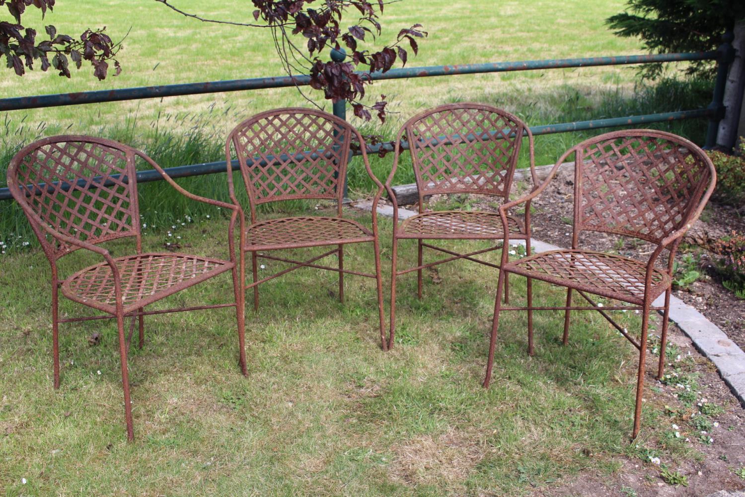 Set of four wrought iron garden chairs.