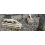 Pair of cast stone reclining whippets.