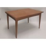 Mid-century teak dining table with extendable leaves.