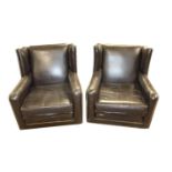 Pair of leather wing back easy chairs.