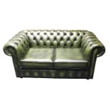 Green leather two seater chesterfield sofa.