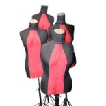 Set of four mannequins on stands.