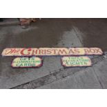 Three hand painted wooden Christmas shop signs.