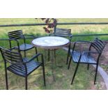 Wrought iron garden table and four metal garden chairs.