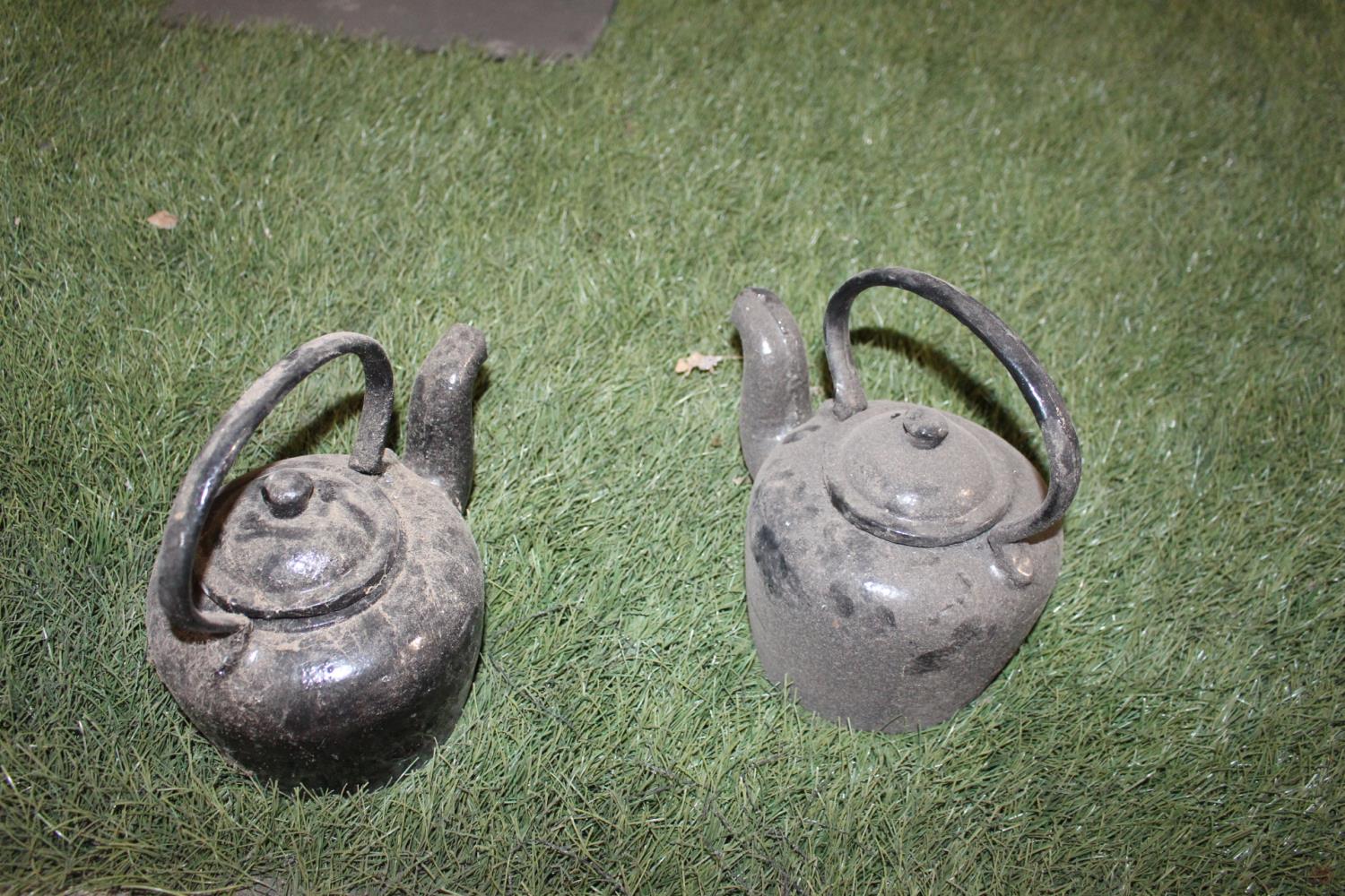 Pair of cast iron kettle.