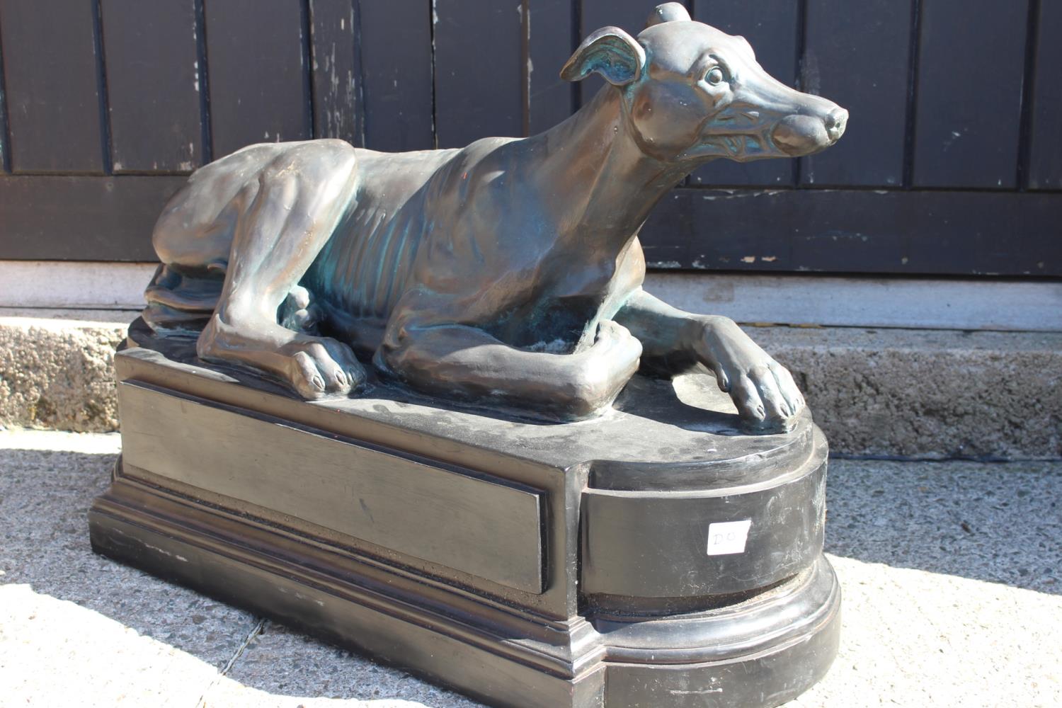 Fibre glass model of a seated Greyhound.