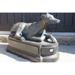 Fibre glass model of a seated Greyhound.