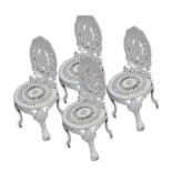 Set of four cast iron garden chairs.