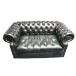 Black leather two seated chesterfield sofa.