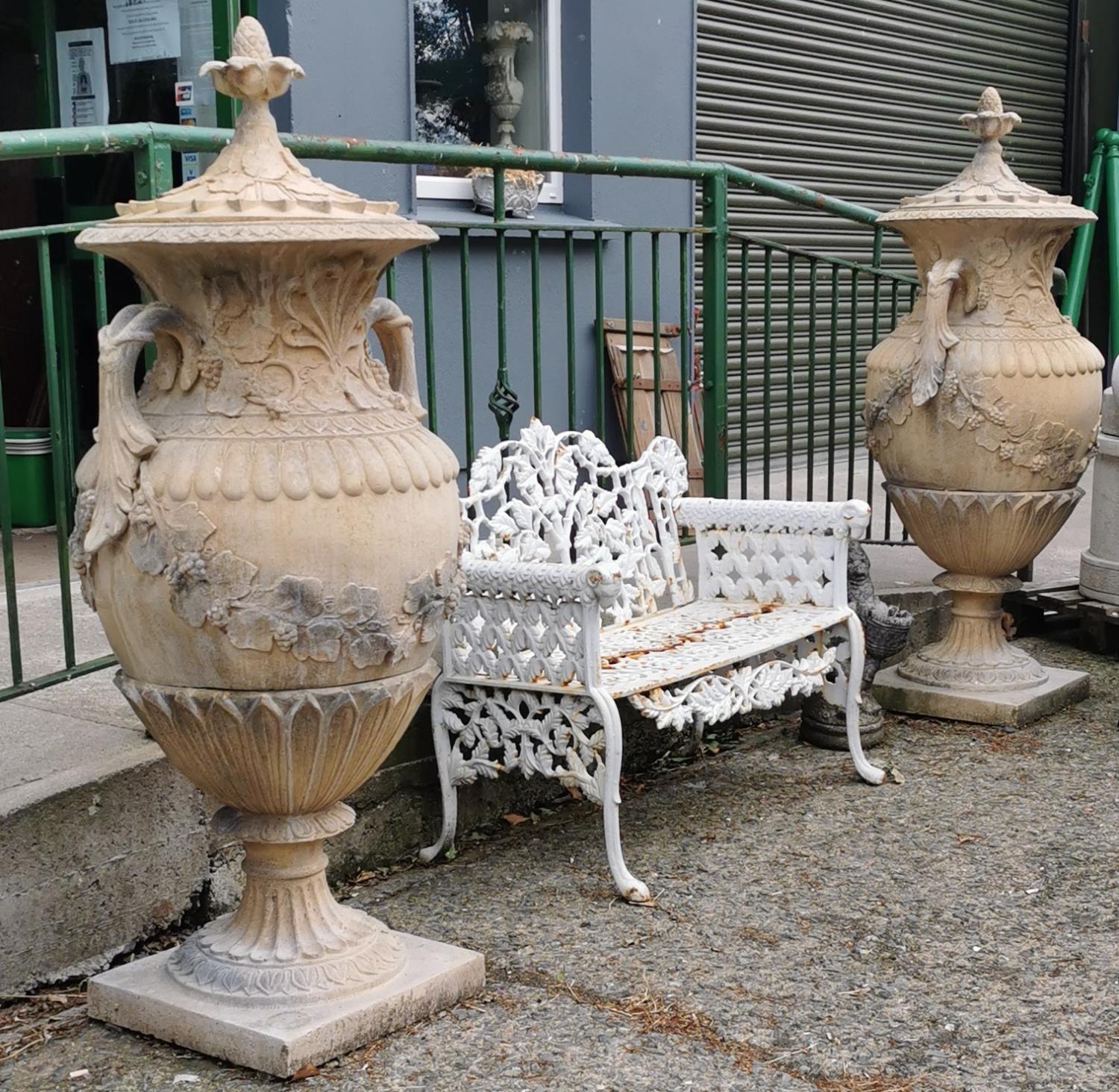 Pair of exceptional quality cast stone lidded urns in the Adams style.