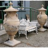 Pair of exceptional quality cast stone lidded urns in the Adams style.