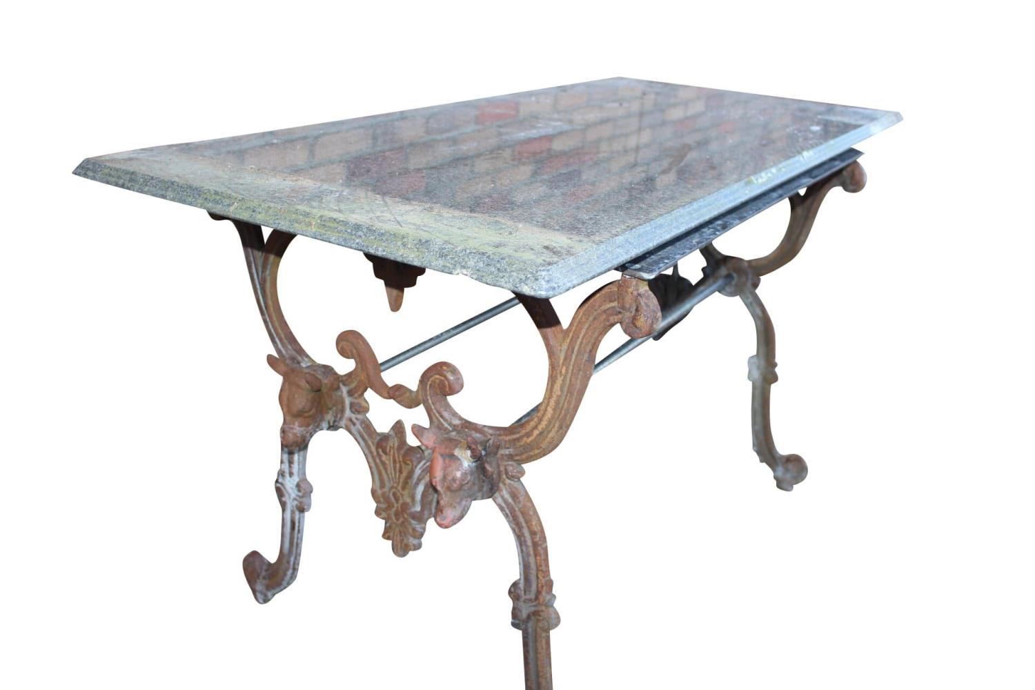 Cast iron garden table with marble top.