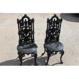 Pair of cast iron garden chairs.