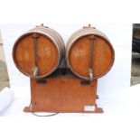 Double barrelled wooden wine dispenser.