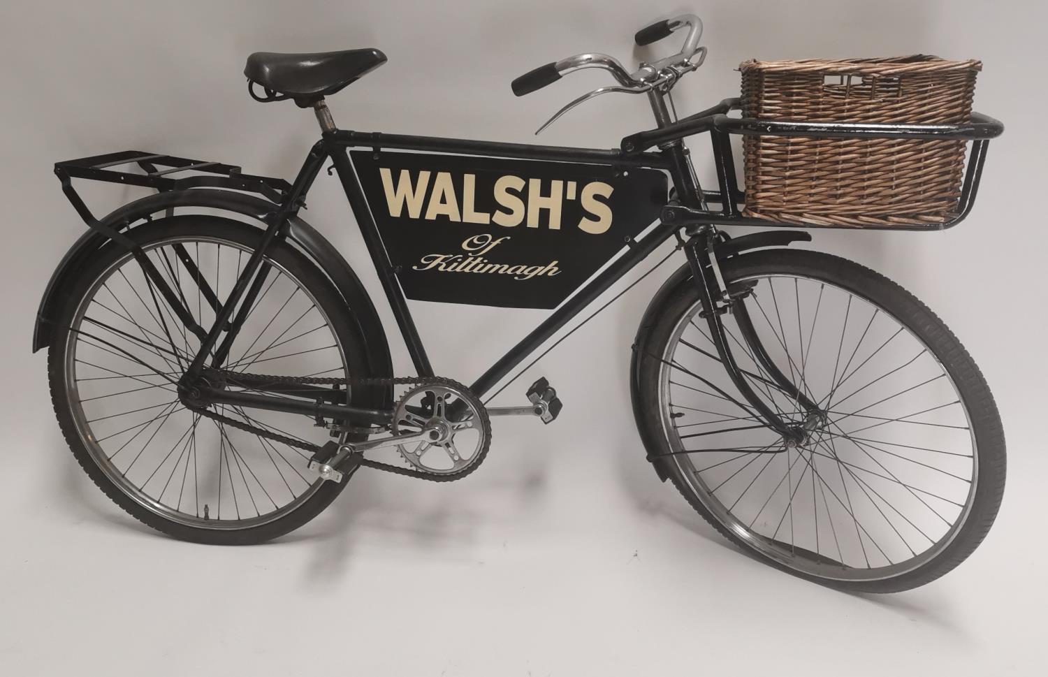 Walsh's shop advertising bike with original wicker basket.