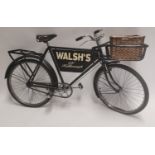 Walsh's shop advertising bike with original wicker basket.