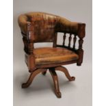 Early 20th C. mahogany and leather swivel captains chair.