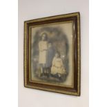 Black and white portrait of three children in wooden frame.