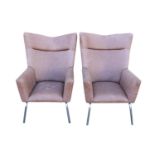 Pair of leather wing back chairs.
