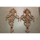Pair of carved mahogany wall plaques.
