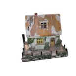 Large resin model of a cottage.