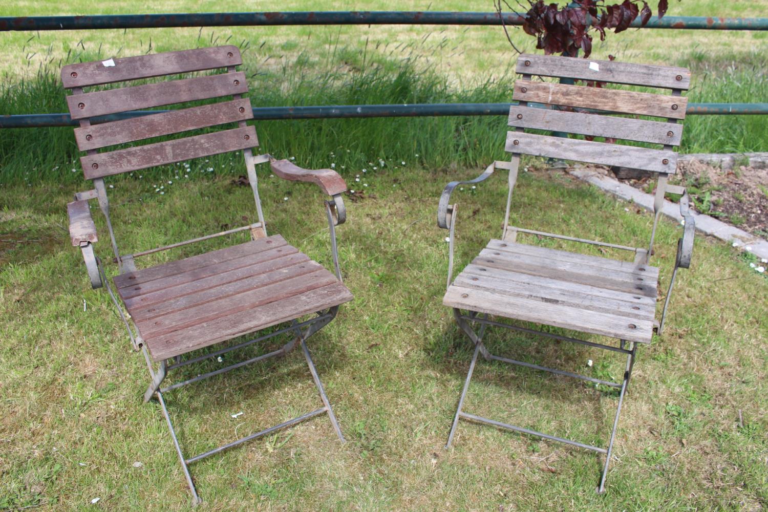 Pair of wrought iron and wooden garden chairs.