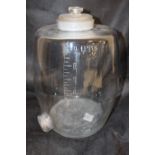 Glass barrel decanter with etched measures .