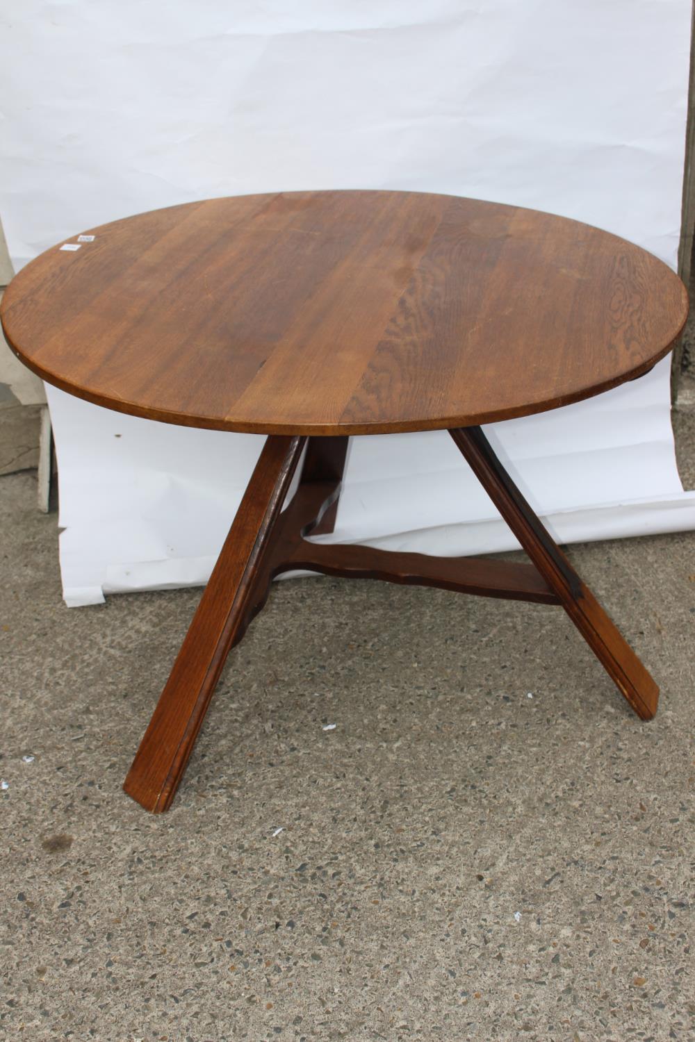 Oak flip top circular table.