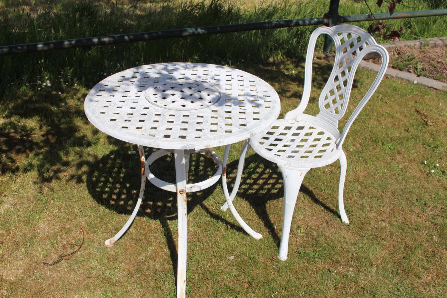Unusual alloy garden table single chair.