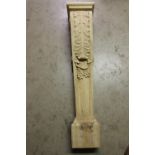 Carved wooden column decorated with acanthus leaf.