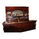 Victorian mirrored bar back and carved mahogany counter with copper top