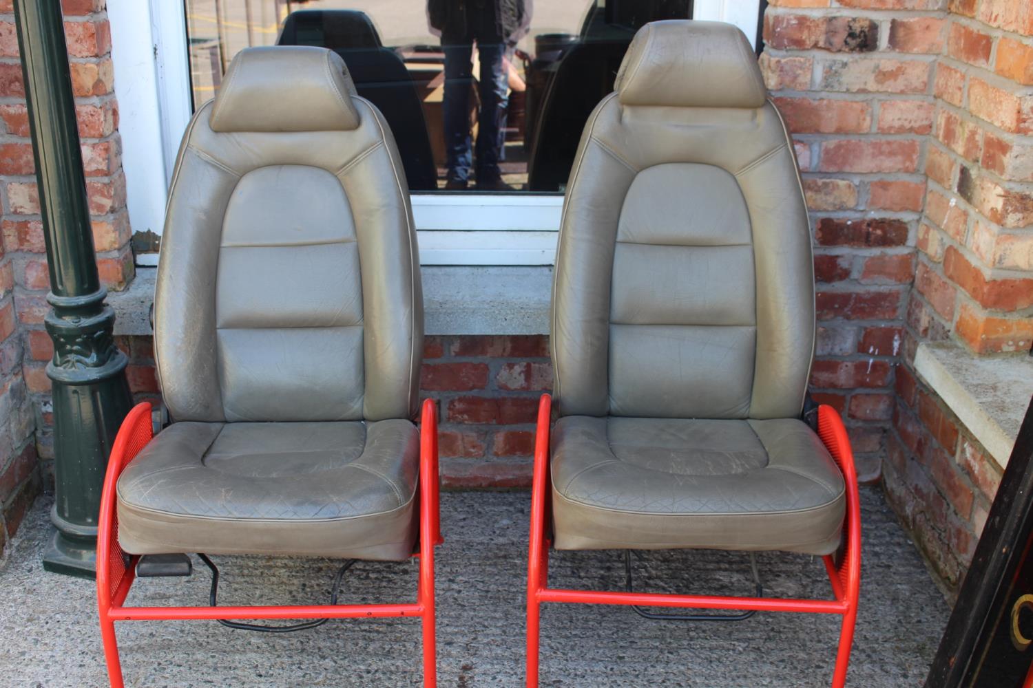 Pair of Saab car seat on metal frames.