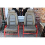 Pair of Saab car seat on metal frames.