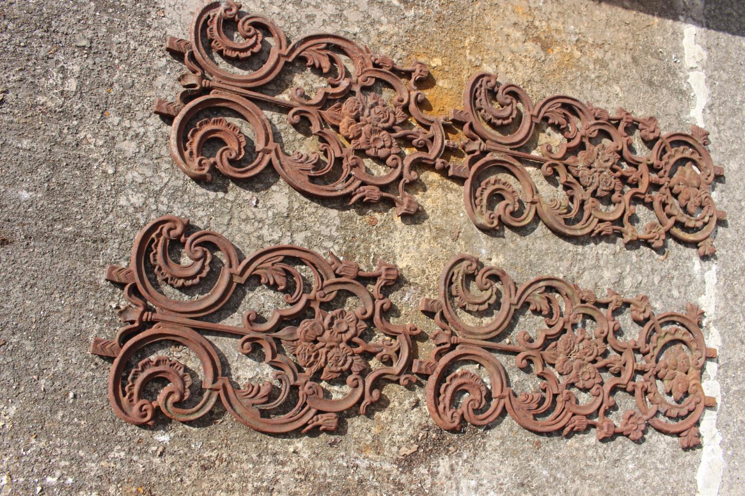 Four decorative cast iron panels.