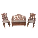 Black forest carved wooden three piece suite decorated with bears .