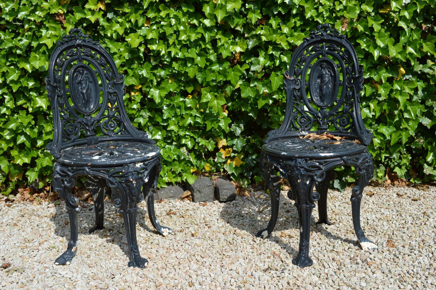 Pair cast iron patio chairs.