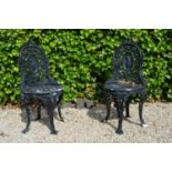 Pair cast iron patio chairs.