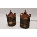 Pair of stoneware flagons in baskets.